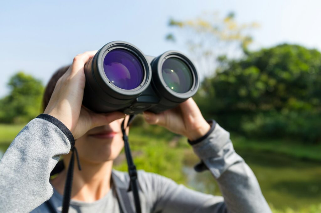 Woman looking though binoculars